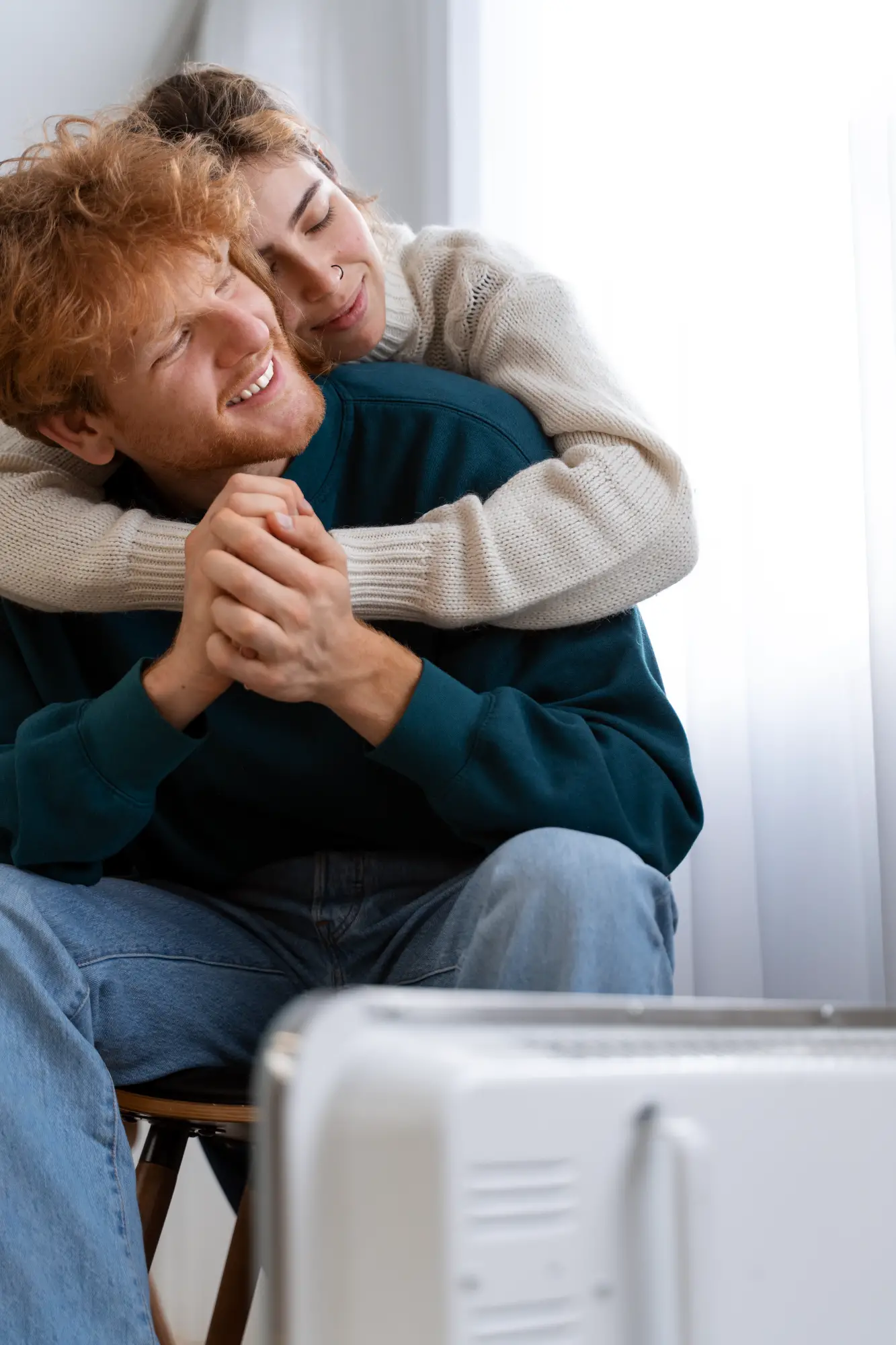 medium-shot-smiley-couple-near-heater
